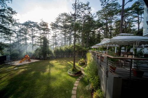 a yard with a park with a playground at Grand Sierra Pines Baguio in Baguio