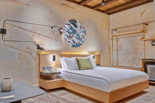 a bedroom with a bed and a table at Mare Cappadocia Adults Only in Göreme