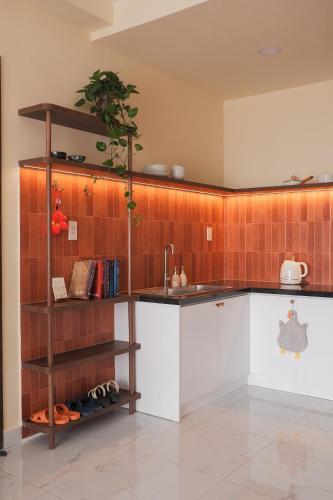 a kitchen with a sink and a counter top at Healing Home - Charm Ruby Apartment in Dĩ An