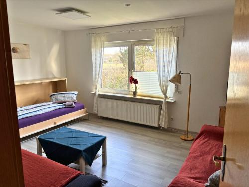 a small room with a bed and a window at Möllers Morgen in Lentföhrden