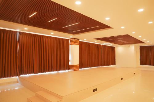 a large room with brown curtains and a dance floor at Hemagiri Palace in Avati