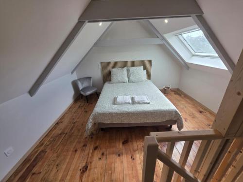a bedroom with a bed in a attic at L'aulne in Carhaix-Plouguer