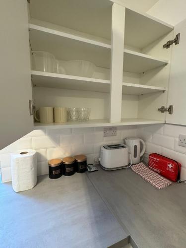 a kitchen with some appliances on the floor at Modern Apartment Bradford City Centre Self Check In in Bradford