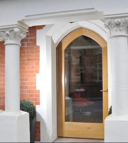 an entrance to a brick building with a wooden door at Taunton House Hotel in Taunton
