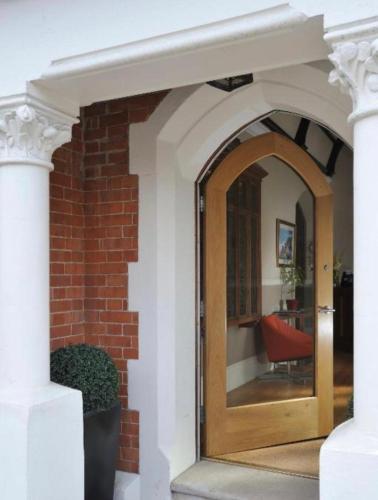 an entry to a house with a wooden door at Taunton House Hotel in Taunton