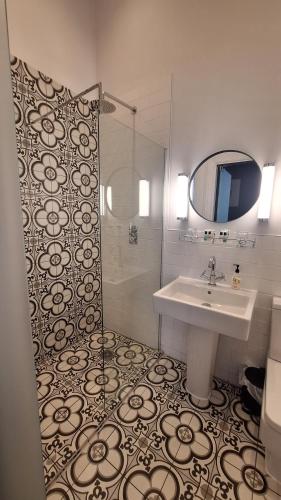 a bathroom with a sink and a shower at The Clock Face Prescot in Prescot