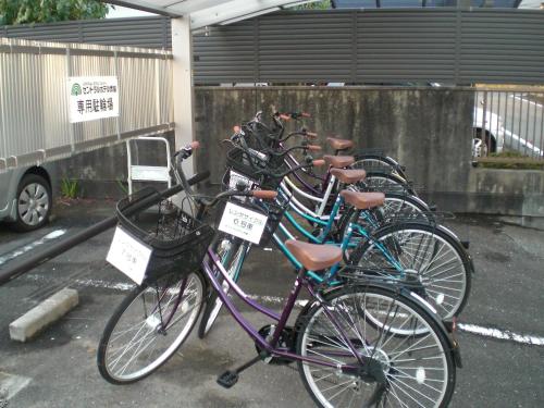 a row of bikes parked in a parking lot at Central Hotel Takeoonsen Ekimae in Takeo