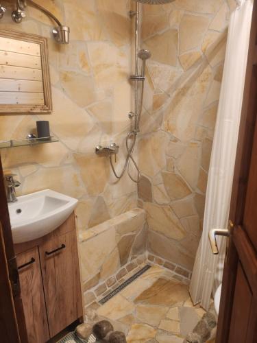 a bathroom with a shower and a sink at Pici vendégház in Noszvaj