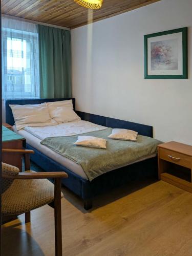 a bedroom with a bed with two pillows on it at Willa Perełka in Mielno