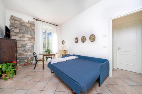 a bedroom with a blue bed and a table at Residence in Villa Giulia in Grado