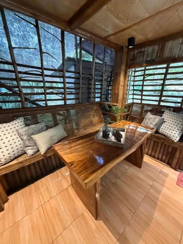 a room with benches and a table in a room with windows at Hangin at Agos Resort in Nasugbu