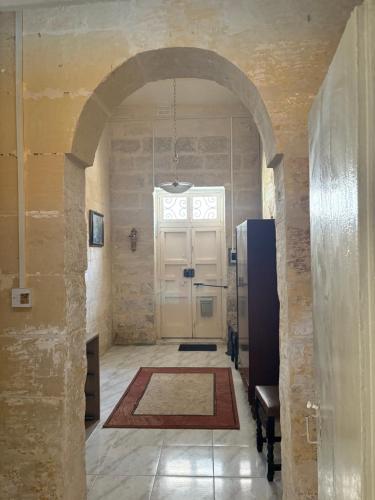 a hallway with a white door in a building at Guesthouse 39 in Mqabba