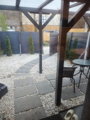 a patio with a table and a bench at Pici vendégház in Noszvaj