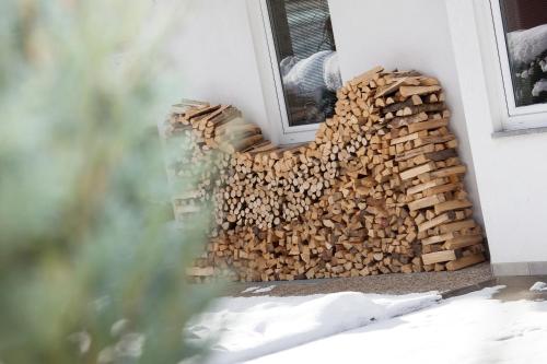 a pile of fire wood next to a window at Ferienhaus Alex in Wiesing