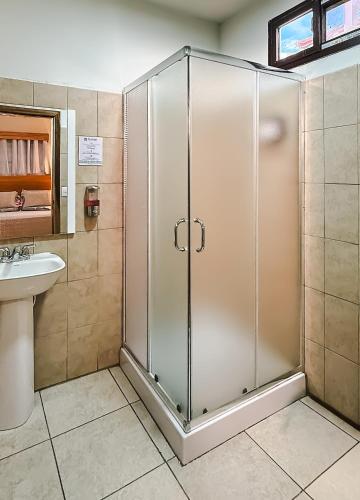 a shower stall in a bathroom with a sink at Hotel Palmazul - Viña del Mar in Omoa