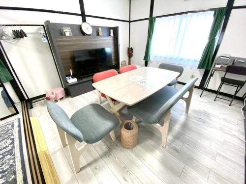 a dining room with a table and chairs at comodo inn HANAZONO in Aomori