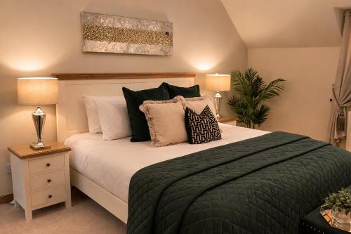 a bedroom with a large bed with pillows at Avalon in Inverness
