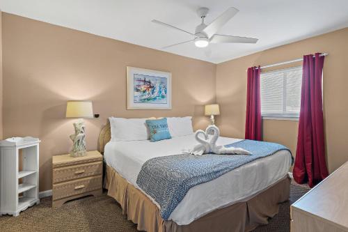 a bedroom with a bed with a stuffed animal on it at Windancer 110 in Destin