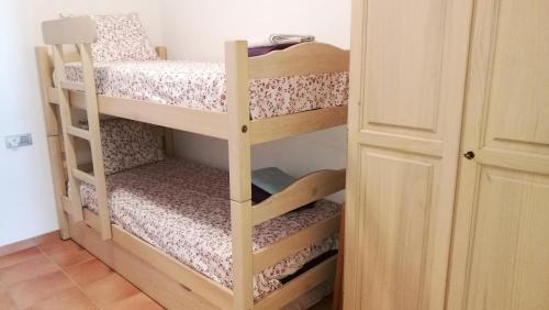 Ein Schlafraum mit zwei Etagenbetten und einer Tür in der Unterkunft Carudo in Llafranc