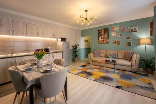 a living room with a table and a couch at Smart Apartments Central in Sighişoara