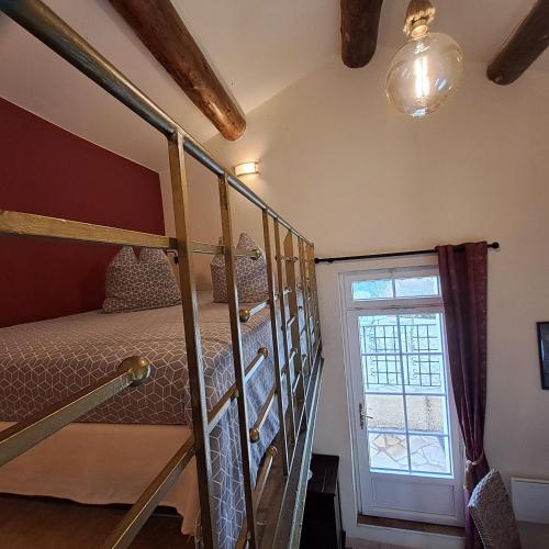 a bedroom with two bunk beds and a window at Le Mas des Deux Tilleuls in Sablet