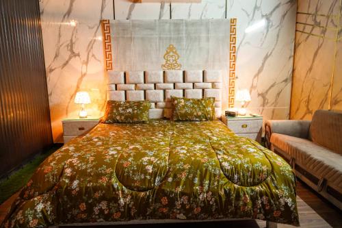 a bedroom with a large bed and a couch at Proxima Quarters in Rawalpindi