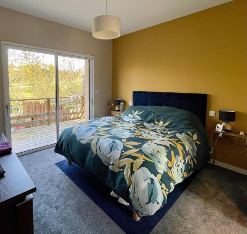 a bedroom with a bed and a large window at Tardif in Vitré