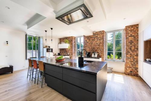a kitchen with a large black island in a room at Moulin in Vitré