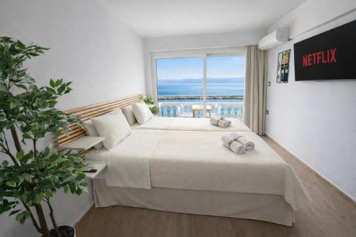 a hotel room with two beds and a view of the ocean at Opal Apartments Luxury by the Sea in Hersonissos