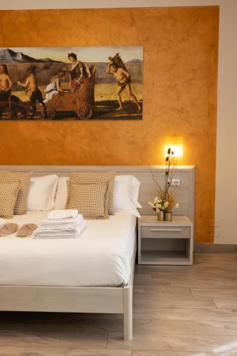 a bedroom with a bed and a painting on the wall at B&B Domus Vettii in Pompei