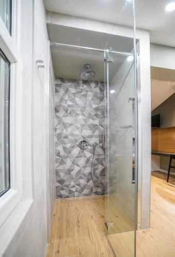 a walk in shower with a glass door at Seaview Villa Rajmond in Podstrana
