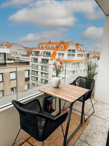 a table and chairs on a balcony with a view at la MERéMOI - Duplex Knokke with balcony and free parking in Knokke-Heist