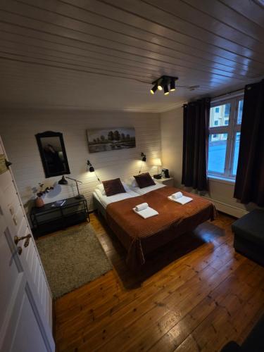 a bedroom with a large bed and a window at Stryn Kaffebar & Vertshus in Stryn