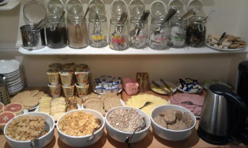 a kitchen counter filled with lots of different types of food at Classic Hyde Park Hotel in London