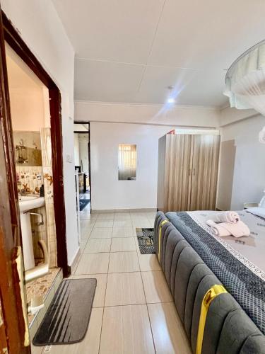 a hotel room with a bed and a mirror at Elite suite 1bedroom in Busia