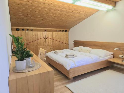 a bedroom with a large bed and a wooden ceiling at Ferienwohnung Felder in Bürs