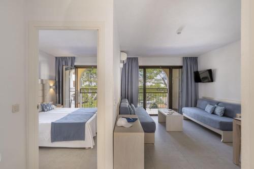 a bedroom with a bed and a living room at Apartamentos Casa Vida in Santa Ponsa