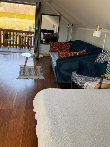 a living room with a couch and a table at Laki house in Jasień