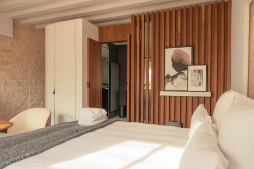 a bedroom with a bed and a picture on the wall at Château Fonroque - Camomille in Saint-Émilion