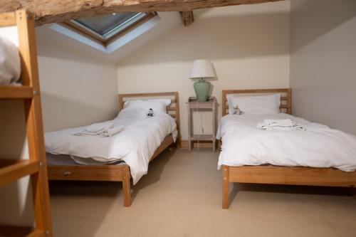 a bedroom with two bunk beds and a window at Longère de charme en pleine nature in Chillac
