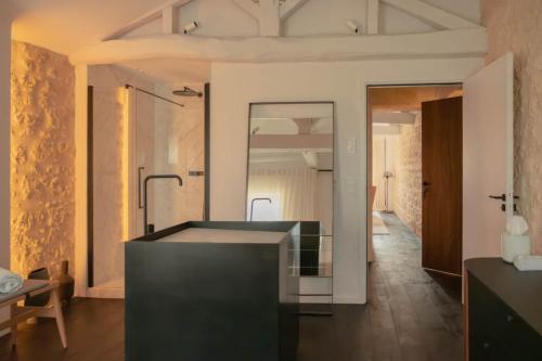 a bathroom with a tub in the middle of a room at Château Fonroque La Suite in Saint-Émilion
