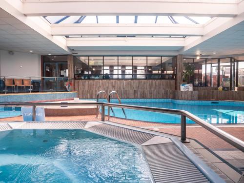 a pool in a hotel with a swimming pool at Beverley Park in Goodrington
