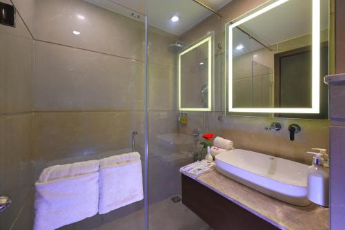 a bathroom with a sink and a glass shower at The Retreat in Agra