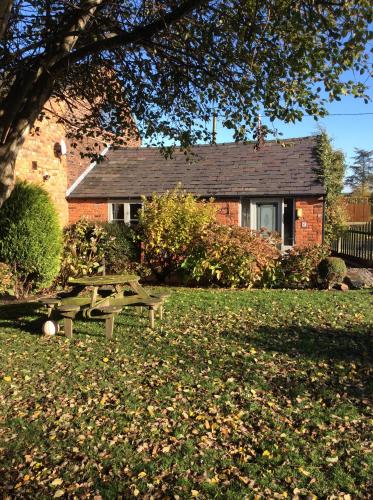 a picnic table in front of a house at The Barn Bed and Breakfast in Liverpool