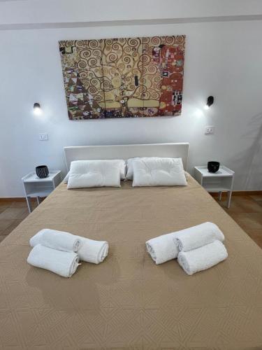 a large bed with three white pillows on it at Regina Margherita in Crotone