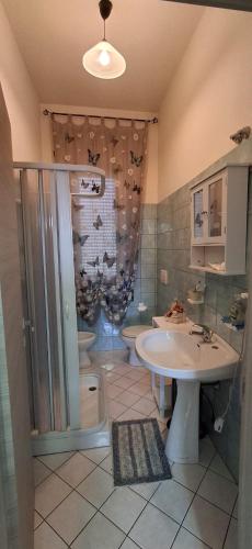 a bathroom with a sink and a shower and a toilet at Stella Bianca in Giulianova