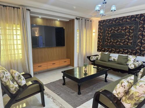 a living room with a couch and a coffee table at Home away from Home in Komé