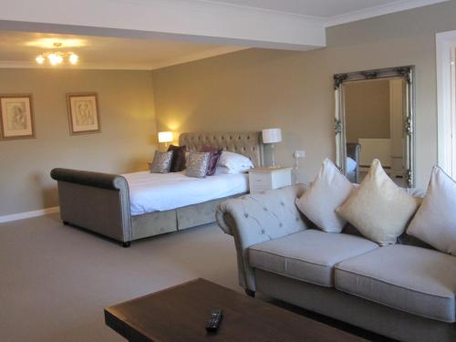 a hotel room with a bed and a couch at Druid House in Christchurch