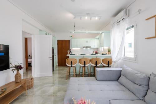 a living room with a couch and a kitchen at CorfuLevante Sea View in Barbati