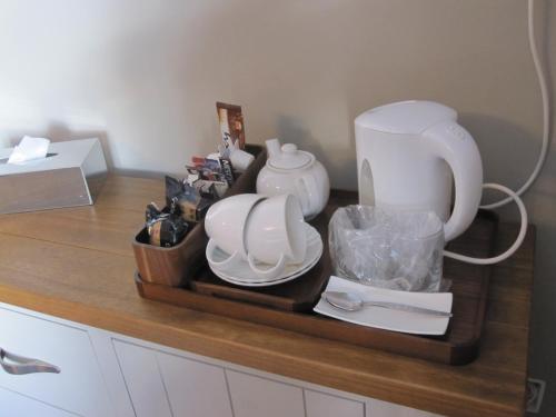 a counter with a tray with dishes and a blender at Druid House in Christchurch